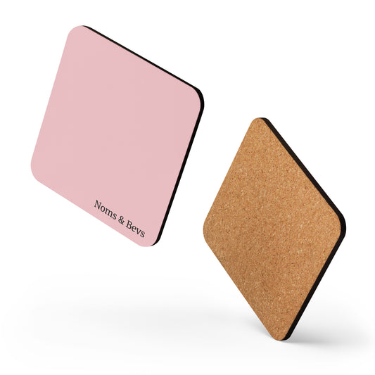 Product mockup of a Rosé Pink Coaster with the Noms & Bevs logo and cork backing.